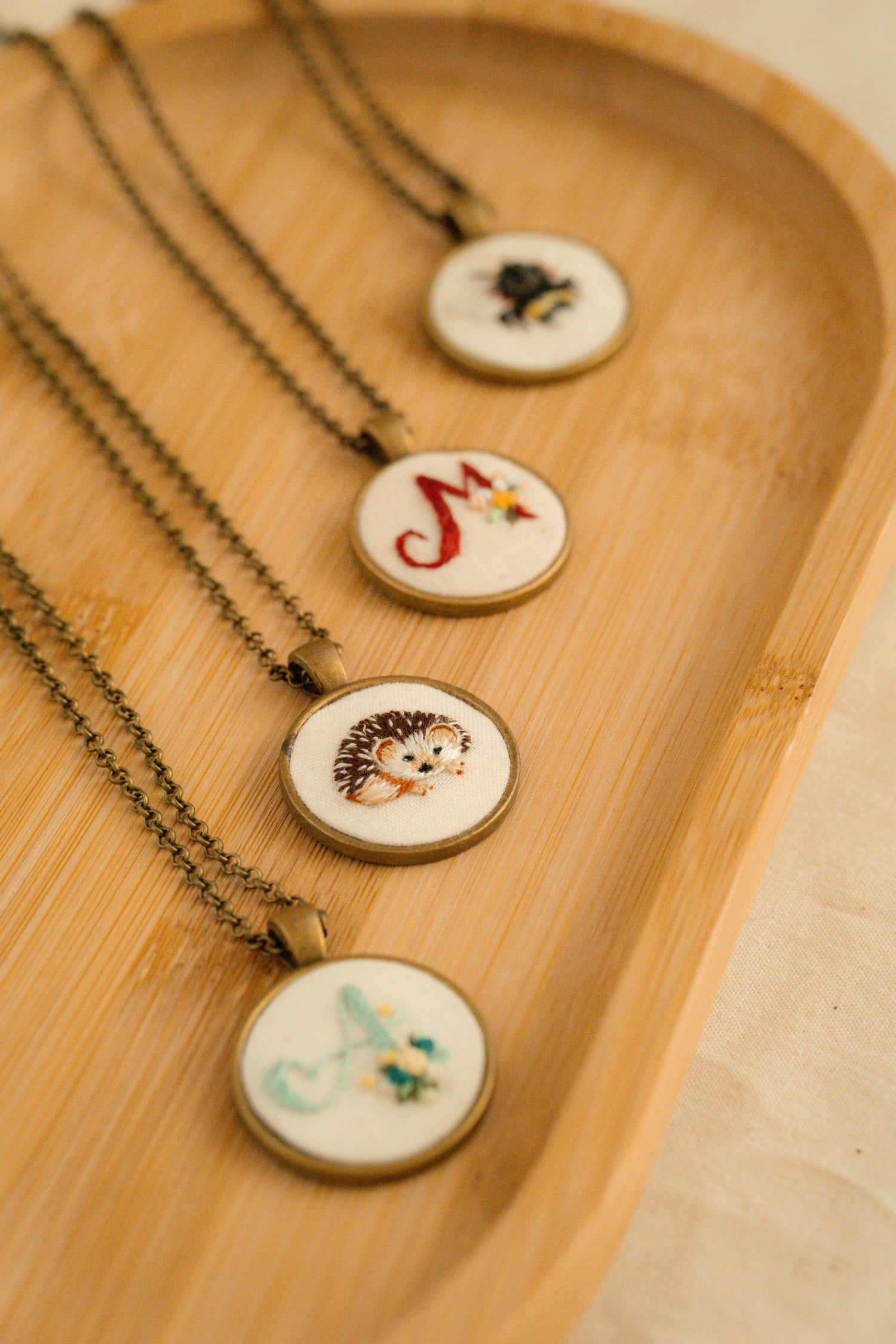 Hand-embroidered pendant.